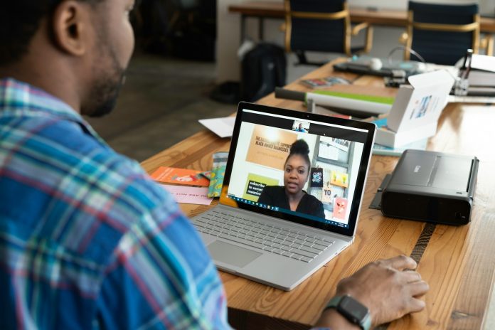 Photo by LinkedIn Sales Solutions man in blue and white plaid shirt using macbook pro